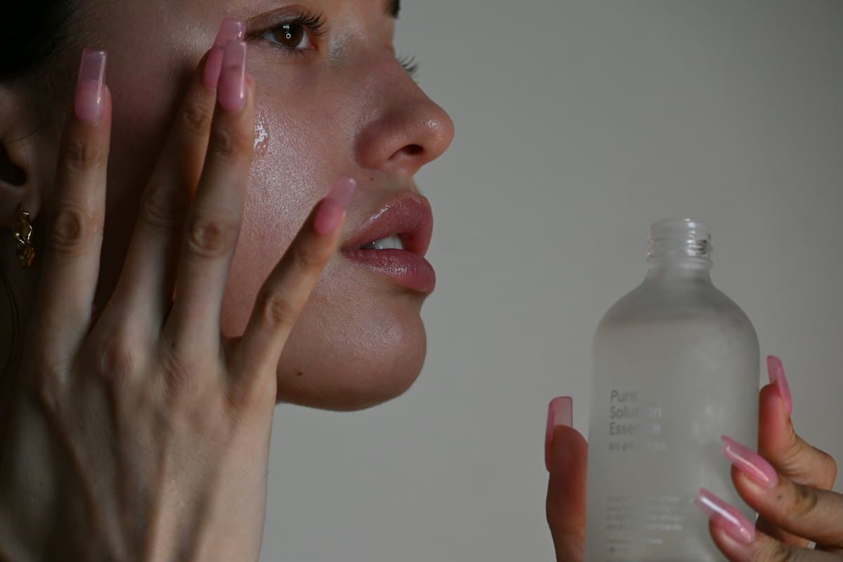 Person applying serum to their cheek